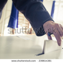 stock-photo-hand-of-a-person-casting-a-ballot-at-a-polling-station-during-voting-239614381