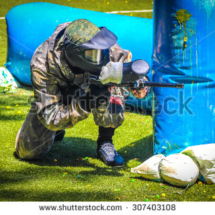 stock-photo-paintball-sport-player-in-protective-uniform-and-mask-playing-with-gun-outdoors-307403108