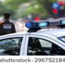 stock-photo-police-officer-emergency-service-car-driving-street-with-siren-light-blinking-296752184