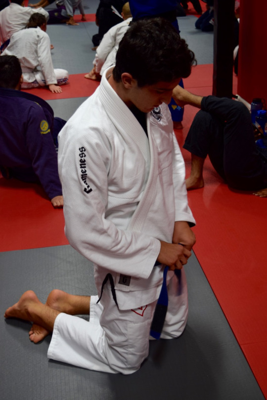 Raphael Diogo ties his belt as he prepares to begin his Jiu Jitsu training on Monday night.