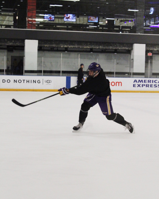 Cade aims the puck and shoots after making a breakaway from the rest of his team during a scrimmage.