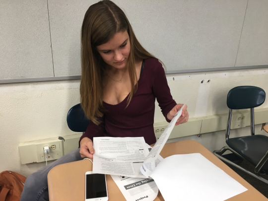 Junior Jolie Hackney reads through an instruction packet while at a meeting in the Model UN room this Tuesday at lunch. This meeting was for students that are volunteering at the Samburu event that is taking place this upcoming Saturday.