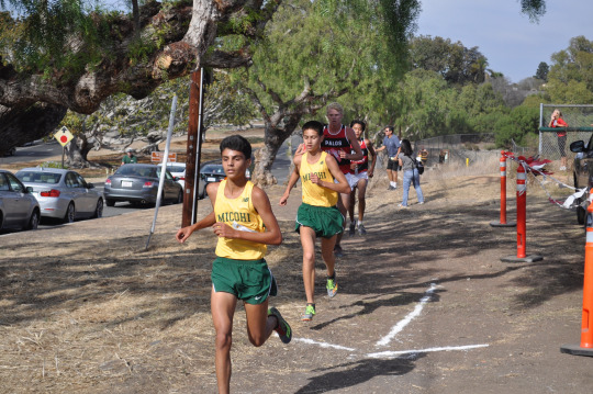Senior Matt Arruda and Sophomore Cy Chittenden work together to run past a member of the Palos Verdes High School team while on the second mile of the race. 