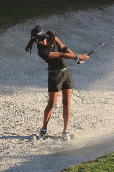 Varsity senior Lexi Nielsen chips the ball from the bank on the 6th hole.