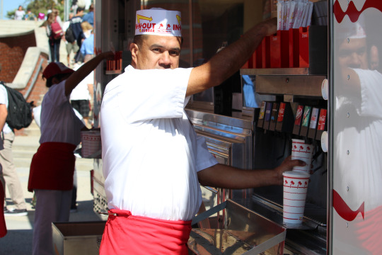 An In-N-Out worker fills a cup with the students drink of choice during the honor roll lunch this Tuesday.