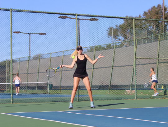 Sophomore Varsity player Lindsay Giese hits the ball from behind the baseline to the other team.
