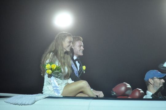 Seniors Hogan Webb and Delaney Whittet ride in the car before they go onto the field for the crowing of the homecoming king and queen. 