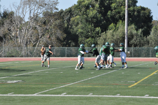 Head Coach Mr. Donald Morrow throws a ball to one of his players during a routine practice for the Varsity Mira Costa Boys Football Team. The Mira Costa Boys recently defeated the Morningside Varsity Team 40-6 at the Homecoming game, with a game against Palos Verdes this Friday.
