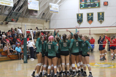 The Varsity Girls Volleyball team starts off their sweep with a cheer.