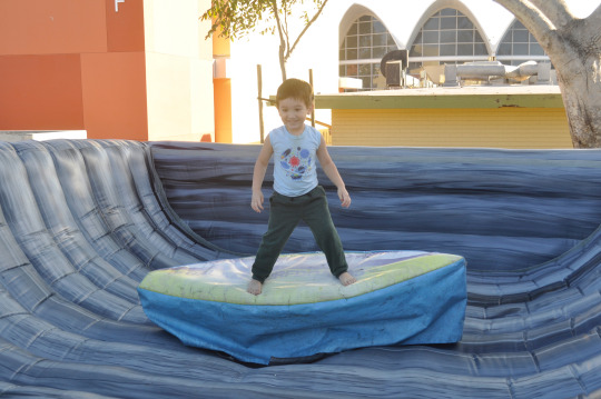  One of the forms of entertainment at Costapalooza was a bounce house with a motorized surfboard on it. 
