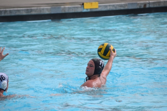Water polo center man shoots the ball late in the first half to try to get a lead up on Loyola.