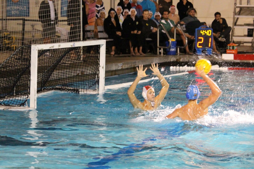 Jere Ashby, Goalie, attempts to block a shot by a Corona Del Mar player during the first Boys Water Polo CIF game. The boys lost to CDM with a final score of 7-14. 