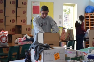 Junior, Trever Vanthof, loads the gifts into “Salvation Army” boxes that will be given to children on Christmas.