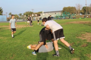 Boys Rugby players practice their tackling.
