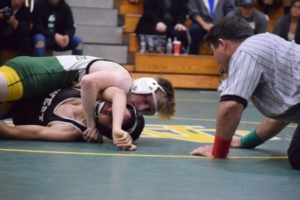 Varsity Sophomore Jacob Gordon scores three near-fall points, later pinning his opponent, in a duel meet against the West Torrance Warriors.