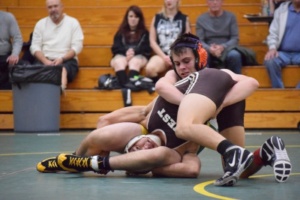 Tyler Gordon, another varsity Sophomore, sinks a ball and chain to turn his opponent to his back.