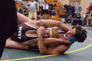 Varsity Senior Jean-Paul Bosnoyan cross faces his opponent for a pin in the second period, scoring six points for Mira Costa.