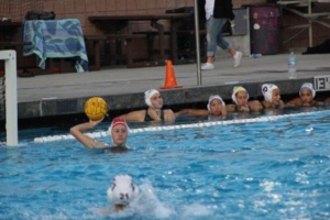 Goalie Katie Nitzberg passes the ball to her teammate after blocking a shot from the other team. 