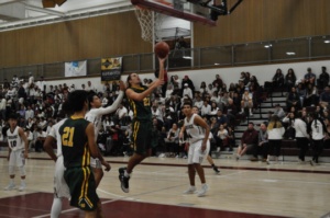 Senior Cameron Steen shoots the ball after dribbling towards the basket.  