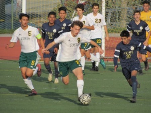 Mira Costa Senior Trevor Taub kicks the ball away from his opponent during a Varsity Boys’ Soccer game on Tuesday, December 13th. This was the Varsity Boy’s fifth game of the season, and marked a decisive victory against the Animo Varsity Boys’ Soccer Team.