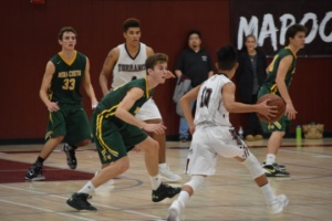 Senior Jackson Weaver plays defense at the top of the key against Torrance point guard.