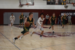 Guard Ryan dribbles towards Costa’s basket on a break away.