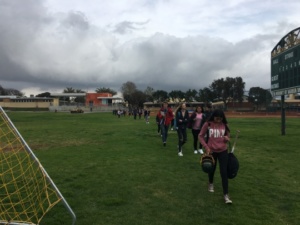 Mira Costa High School students walk across the baseball field towards Meadows after 5th period this Monday. The construction taking place on the fields forces students to walk across the field instead of down the ramp to leave school. 