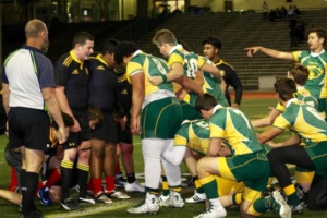 Varsity boy’s rugby players stand in ready position to begin the next play.