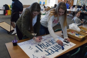 ASB juniors Kara Milewski and Natalia Givot make new signs for winter formal Tuesday in room 40.  The last round of signs were destroyed in last weeks rain storm.