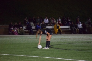 Junior Olivia Vega places the ball for a free kick after being fouled by a Redondo player.