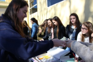 Sophomore Kristen Cordero buys Becker Cookies from the Child Hope Club on Wednesday at lunch. This was the second Club Day this year and it is an event that helps clubs raise money for what they do in their club. 