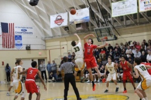 Senior Jonas Pittman starts off the game with the tip off getting Costa the ball. 