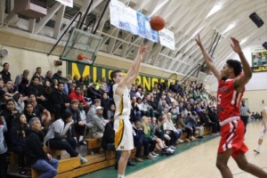 Senior Jackson Weaver shoots a three pointer at the boys basketball Varsity game on Tuesday night in the Fischer Gym. 