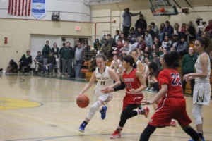 Mira Costa Junior Haley Herdman maneuvers around her Redondo Beach opponent at the Mira Costa Girls Varsity Basketball game on Tuesday night. The game resulted in a decisive Redondo Union victory, despite many offensive efforts by Herdman and her teammates.