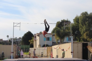 Nicko Parsons throws his legs over the bar making for a successful vault. 