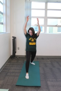 Sophomore Sydney Blum extends her arms and lengthens her legs into Warrior Two pose during Ms. Cross’s fourth period yoga class. In the past semester, the students were taught various poses ranging from standing, to sitting, to breathing based styles.