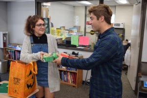 Junior Lauren Smith sells Girl Scout cookies to junior Lucas Prenter Tuesday during their 3rd period APUSH class. In years past the cookie selling fundraiser has brought in thousands of dollars for local girl scout troops. 
