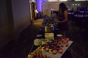 Mira Costa students pause from the dance to fill their plates at the buffet. The caterer of the dance supplied students with different dinner options, followed by a variety of different desserts.