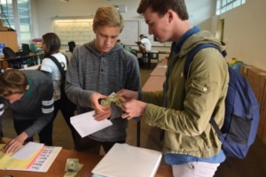 Senior Carson Phillips pays Sophomore ASB member Malcolm Kluth for admission into the futsal tournament at lunch in the ASB room. Kluth and fellow ASB member Max Taylor were put in charge of organizing Mira Costa’s first ever student futsal tournament.