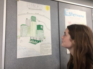 Sophomore Amanda McDonald looks at poster of utopias in Mrs. Valbuena’s English class on Wednesday during first period. Valbuena’s class made their own utopias to prepare for reading the book 1989.