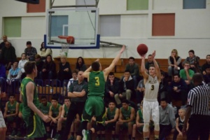 Senior Ryan White puts up a three pointer over a St. Joseph player. White played through an injury after suffering a broken ankle earlier in the season.