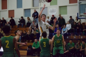 Jonas Pittman elevates over a St. Joseph player to put away a floating jump shot. Mira Costa outscored St. Joseph in each quarter except the fourth, when Costa was outscored 25-11.