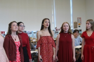 Coterie performs in another english class during fourth period on Wednesday. Junior Olivia Morgan (center) was the lead singer in the song “electric love” that coterie performed. 