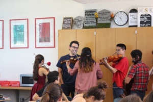 English and Journalism teacher Mr. Chow gets serenaded by the Orchestra. As orchestra performed they created a circle around Mr. Chow, engulfing him in the music. 
