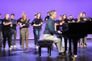Choir director, Micheal Hayden, plays the piano at the Black History Month Assembly today while choir students sing during fourth period. This Assembly was Mira Costa's fourth Black History Month assembly. 