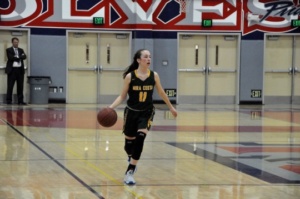 Mira Costa Junior Haley Herdman dribbles the ball down the court in an attempt to score against the Martin Luther King, Jr. Varsity Girls. Herman scored multiple three-pointers for the Mira Costa Girls in the 3rd quarter of the game.