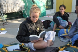 Senior Robin Wilson reads the book Wuthering Heights before she gets in the pool to swim her 200 freestyle. This was the first meet of the season and is known as the Green and Gold meet, where the swim team competed against each other.