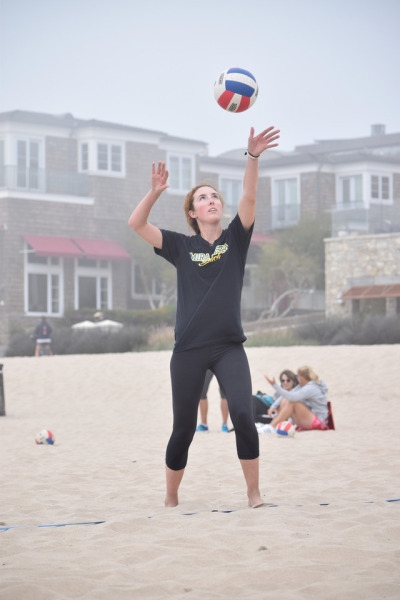 Senior Maddie Micheletti serves the ball during her match against Palos Verdes High School at 3rd Street in Manhattan Beach. Along with her partner, Alexia Inman, she committed to play beach volleyball at the University of California-Berkeley.