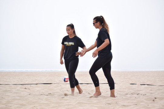 Seniors Sunny Villapando (left) and Rio Frohoff (right) high five in celebration of defeating their opponents. The girls played two sets, and did not allow the Palos Verdes girls to score more than ten points in either one. 