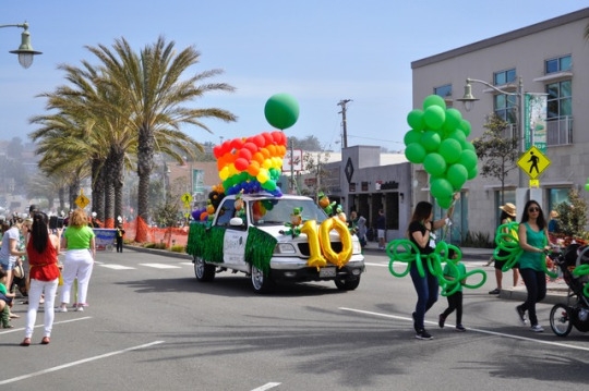 A truck decorated with rainbow balloons and other St. Patrick’s Day decorations drives by the crowd during the beginning of the parade. The truck had a 10 on the front because this was the 10th annual St. Patrick’s Day Parade in Hermosa Beach. 